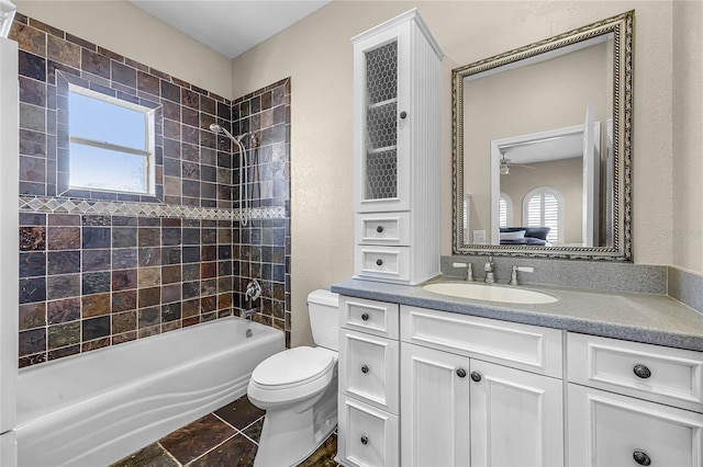 full bathroom featuring shower / bath combination, plenty of natural light, vanity, and toilet