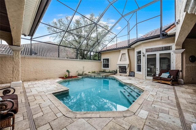 view of pool with a pool with connected hot tub, a lanai, a fireplace, and a patio