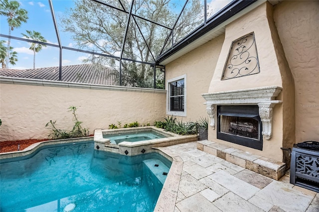 view of swimming pool with exterior fireplace, a patio area, and a pool with connected hot tub