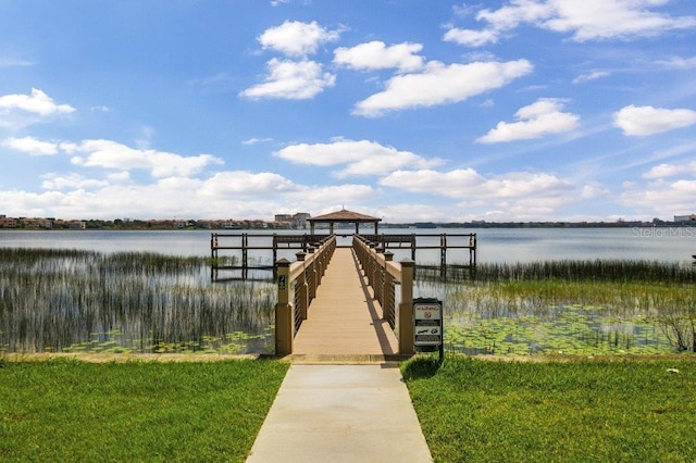 view of dock with a yard, a water view, and a gazebo