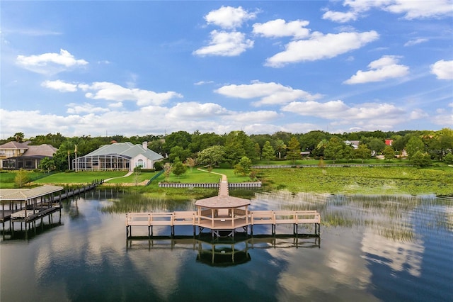 dock area featuring a water view and a lawn