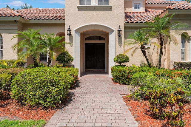 8814 Southern Breeze Dr, Orlando, FL 32836 - doorway to property featuring stucco siding and a tile roof