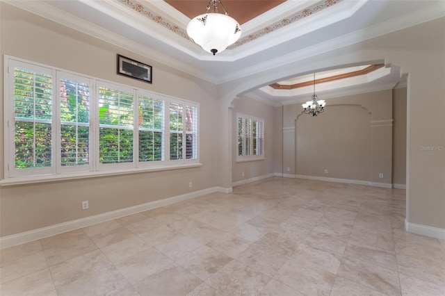8814 Southern Breeze Dr, Orlando, FL 32836 - spare room featuring a raised ceiling, crown molding, arched walkways, a chandelier, and light tile patterned flooring