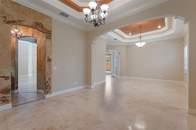 8814 Southern Breeze Dr, Orlando, FL 32836 - spare room with a raised ceiling, arched walkways, a chandelier, and crown molding