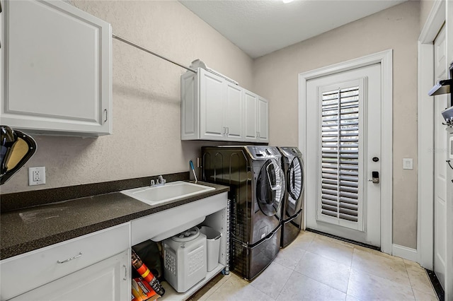 8814 Southern Breeze Dr, Orlando, FL 32836 - laundry area with independent washer and dryer, light tile patterned floors, cabinet space, and a textured wall