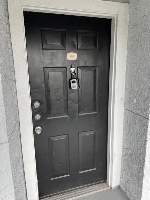 property entrance featuring stucco siding