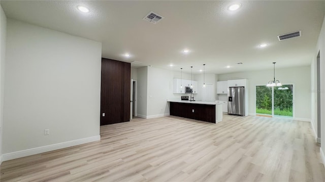 2246 SW 167th Pl, Ocala, FL 34475 - unfurnished living room with light wood-style flooring and recessed lighting
