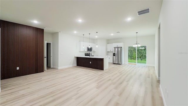 2246 SW 167th Pl, Ocala, FL 34475 - kitchen featuring appliances with stainless steel finishes, light countertops, open floor plan, recessed lighting, and white cabinetry