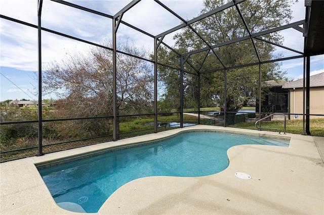 pool with glass enclosure and a patio area