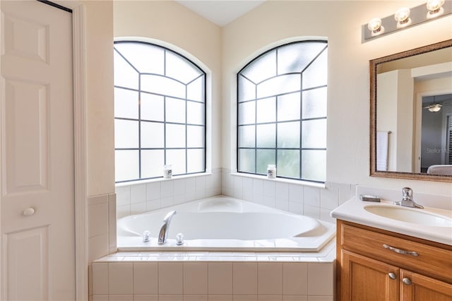 full bath featuring vanity and a garden tub