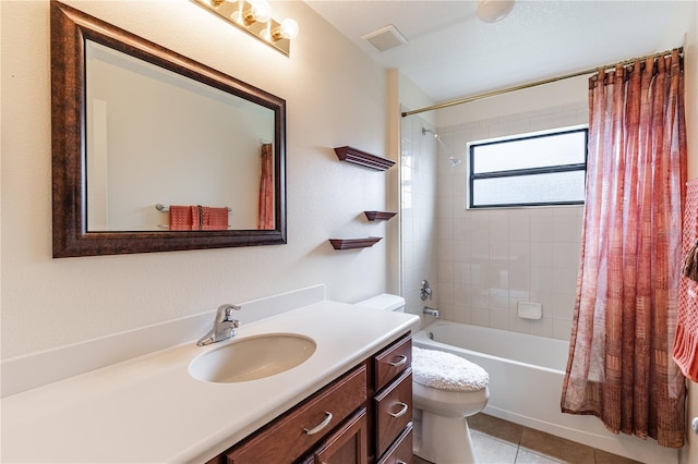 bathroom with vanity, visible vents, tile patterned flooring, shower / bath combo with shower curtain, and toilet