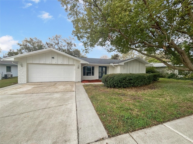 single story home with concrete driveway, central AC unit, board and batten siding, a front yard, and a garage