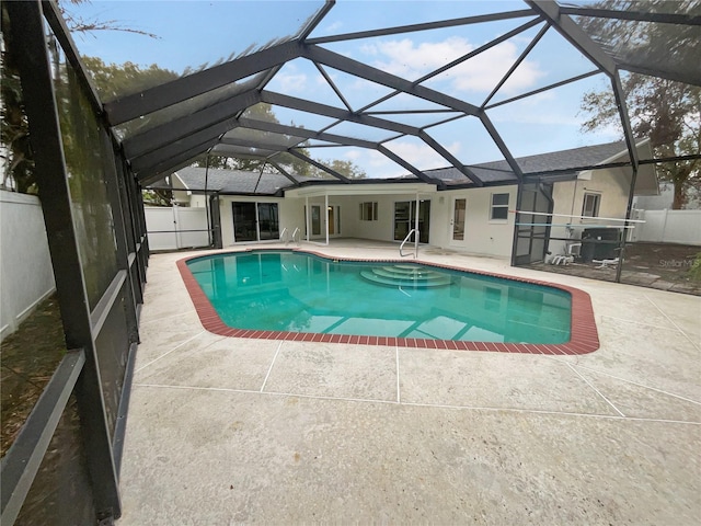 view of swimming pool with a fenced in pool, glass enclosure, a fenced backyard, a grill, and a patio area