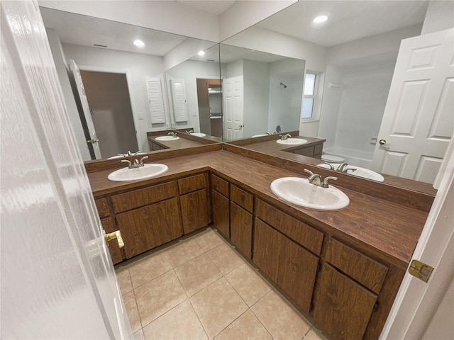 bathroom featuring double vanity, tile patterned flooring, and a sink