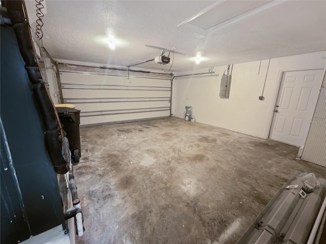 garage with a garage door opener and electric panel