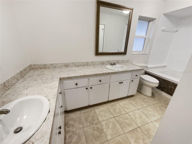 bathroom with toilet, vanity, and tile patterned floors