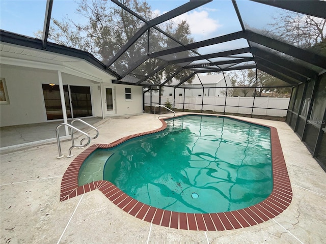 view of swimming pool featuring a lanai, a patio area, fence, and a fenced in pool