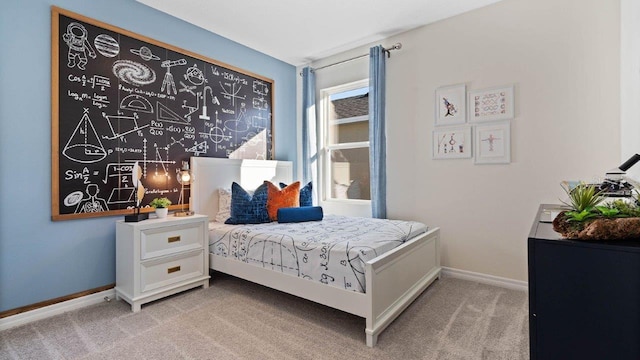 bedroom featuring light carpet and baseboards