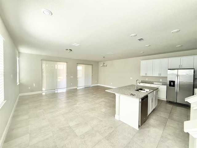 kitchen with stainless steel appliances, a sink, visible vents, white cabinetry, and light stone countertops