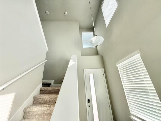 staircase with a towering ceiling