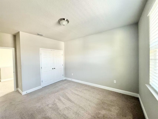 unfurnished bedroom with carpet and baseboards