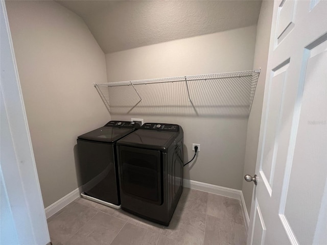 laundry area featuring laundry area, washing machine and dryer, and baseboards