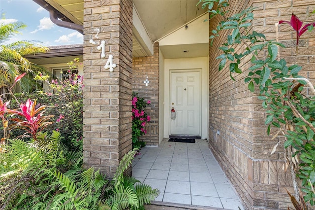 doorway to property with brick siding