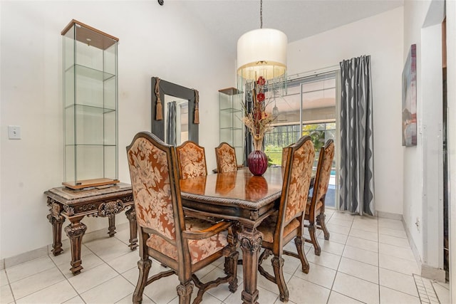 dining area with light tile patterned flooring and baseboards