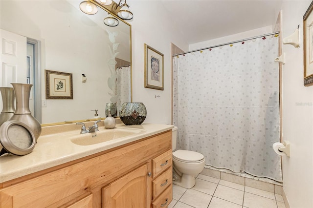 bathroom featuring vanity, toilet, and tile patterned floors