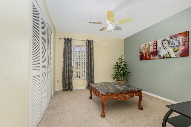 home office with ceiling fan, carpet floors, and baseboards