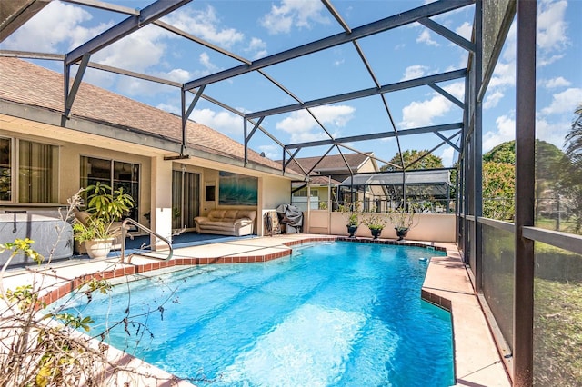 outdoor pool with a lanai and a patio