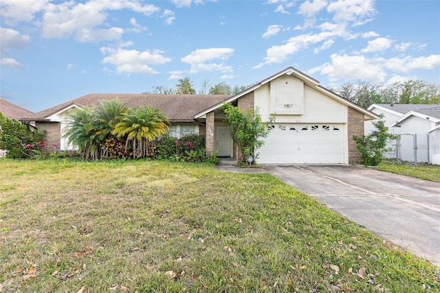 314 Silk Oak Dr, Kissimmee, FL 34743 - view of front of property featuring a front yard, an attached garage, brick siding, and concrete driveway