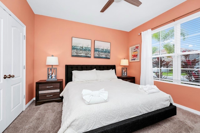 bedroom featuring light carpet, baseboards, and a ceiling fan