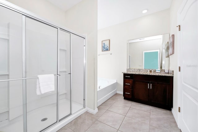 bathroom featuring baseboards, a garden tub, tile patterned flooring, vanity, and a shower stall