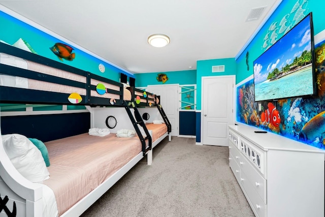 bedroom featuring visible vents and light colored carpet