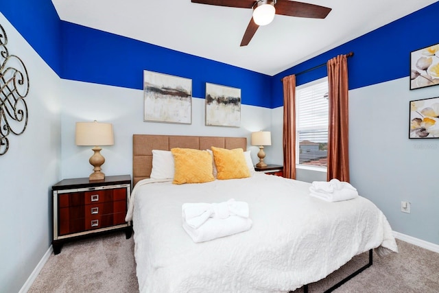 bedroom featuring baseboards, ceiling fan, and light colored carpet