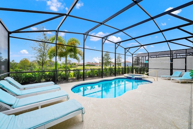 view of pool with glass enclosure, a patio, and a pool with connected hot tub