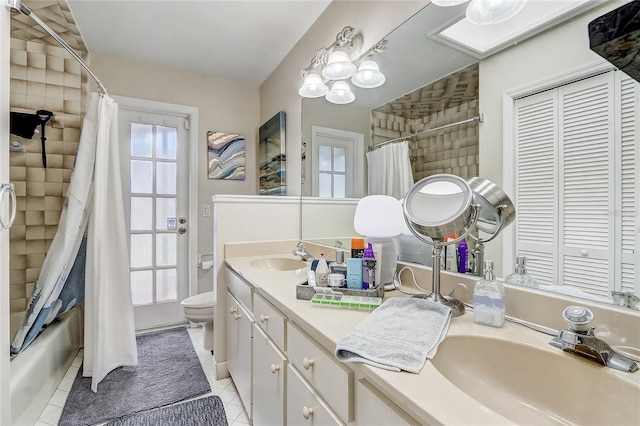 full bathroom featuring toilet, shower / bath combo, vanity, and tile patterned floors