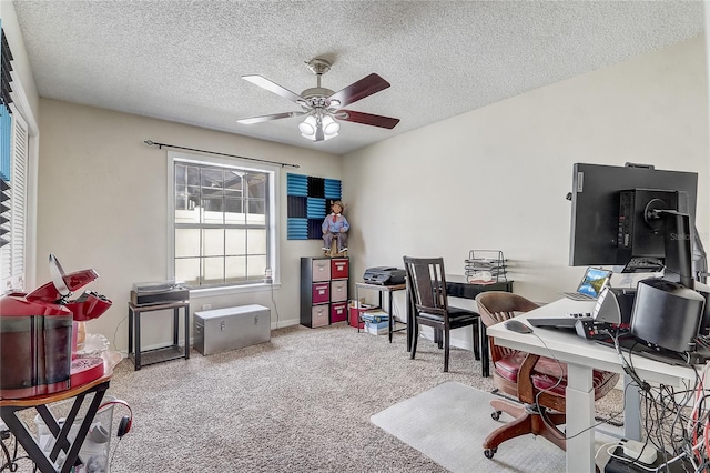 office featuring a textured ceiling, light carpet, and a ceiling fan