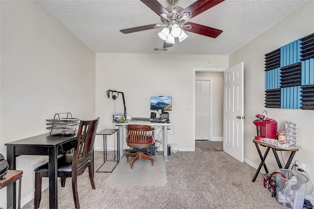 office space with carpet floors, baseboards, visible vents, and a textured ceiling