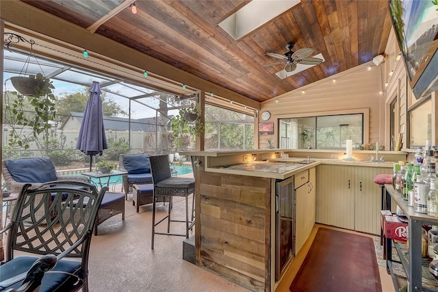 exterior space featuring wooden ceiling, vaulted ceiling with skylight, ceiling fan, and a sink