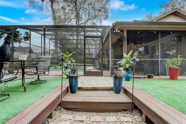 wooden deck with glass enclosure and a patio area