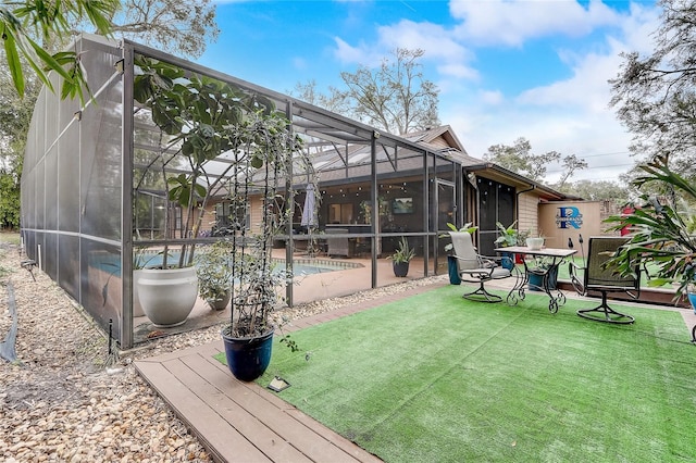 back of property with a yard, a lanai, an outdoor pool, and a patio