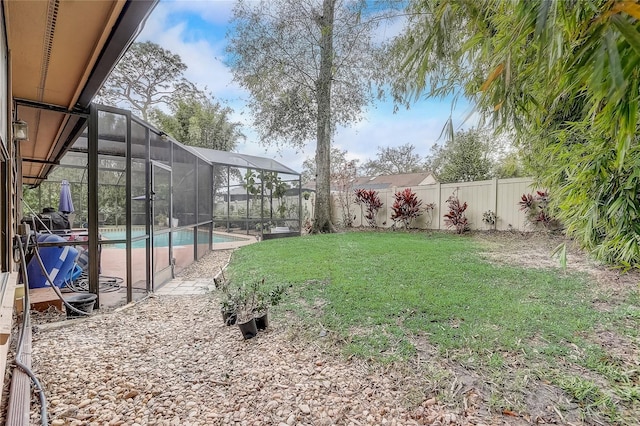 view of yard featuring a fenced backyard, a fenced in pool, and a lanai