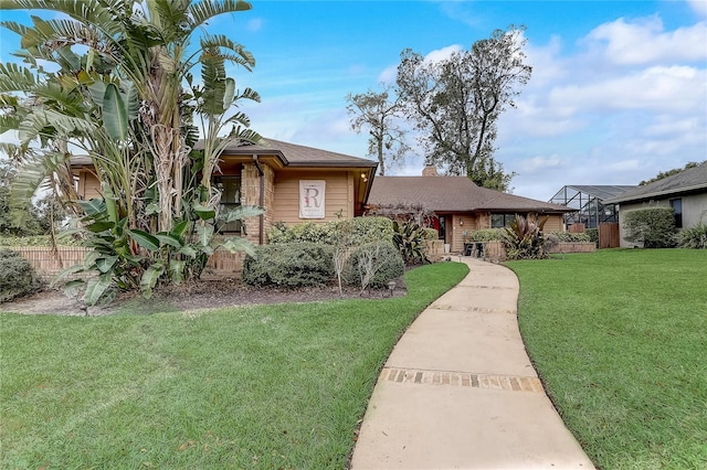 view of front of house with fence and a front lawn