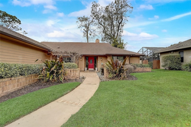 ranch-style house featuring a front lawn, a chimney, a lanai, and fence