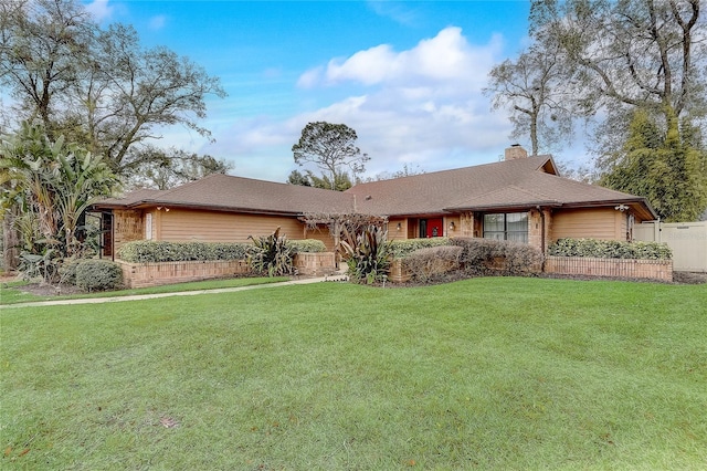 single story home featuring a chimney, fence, and a front lawn