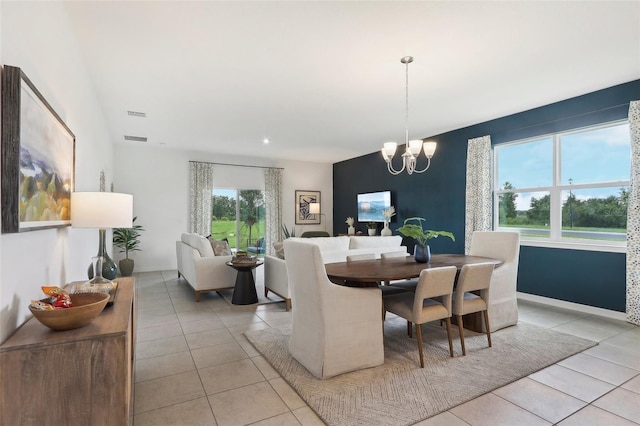 dining area featuring a chandelier, visible vents, baseboards, and light tile patterned floors