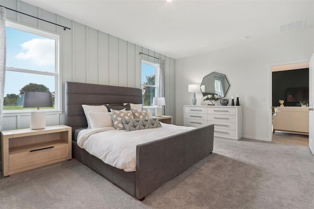 bedroom featuring light colored carpet, visible vents, and baseboards