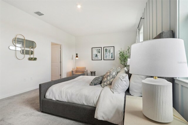 bedroom with light colored carpet, visible vents, and baseboards